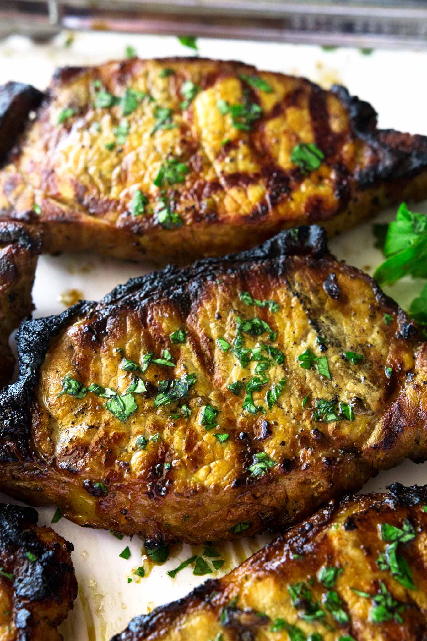 Estas chuletas de cerdo a la parrilla marinadas y súper fáciles se marinan en soja, caldo de pollo y especias y luego se asan a la parrilla a la perfección.