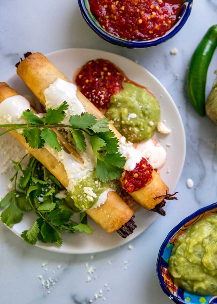 over ead shot of plate of Crispy Beef Flautas
