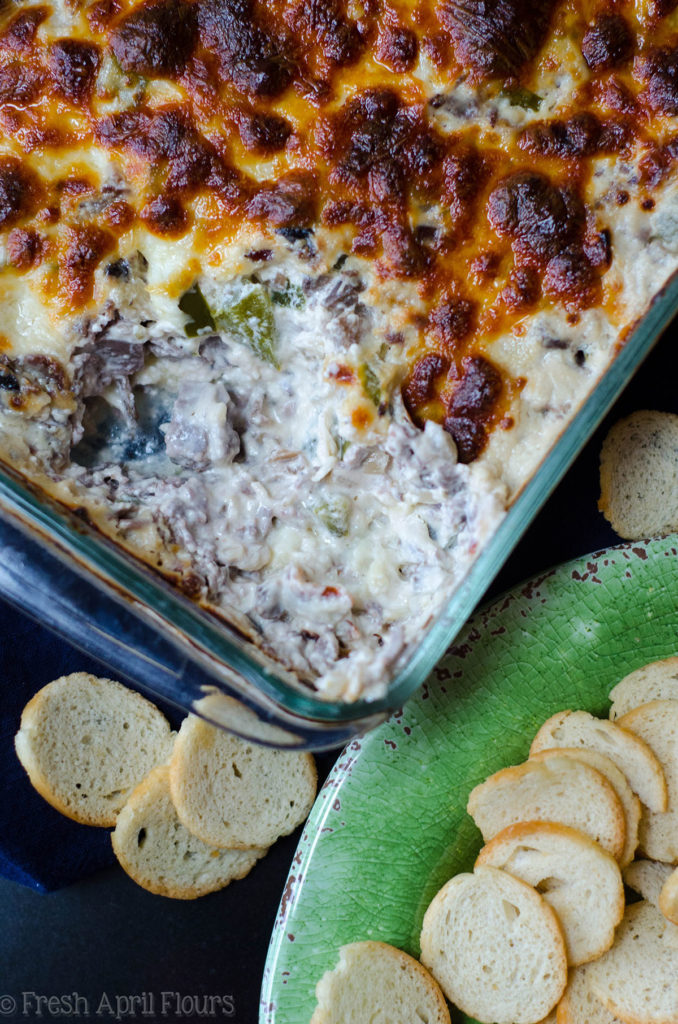 Philly Cheesesteak Dip: salsa cremosa rellena con sabrosas cebollas, pimiento verde, champiñones y carne asada, cubierta con una capa crujiente de queso provolone.