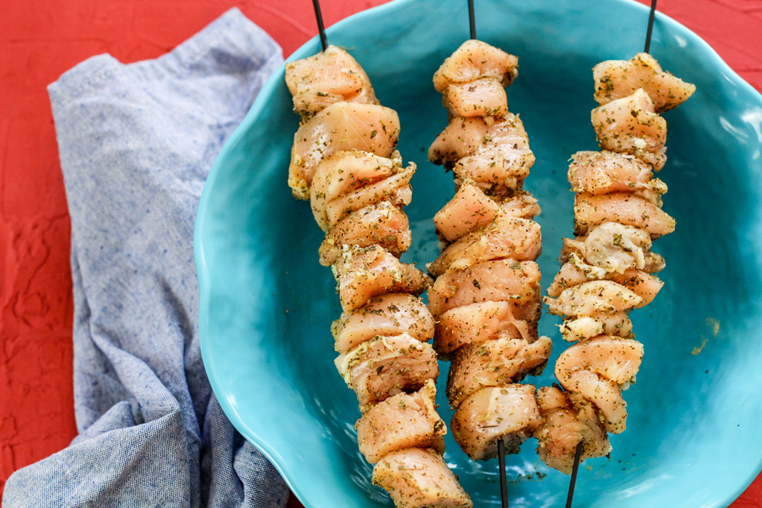 pollo crudo condimentado en brochetas